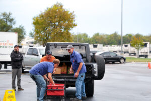 The Food Bank's employees and volunteers loading a federal worker's car with fresh food.